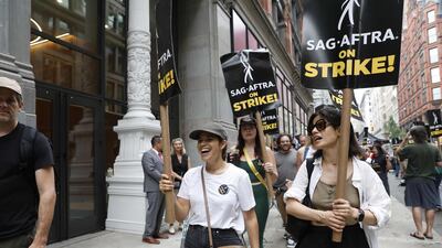 America Ferrera, left, joins the picket line outside Netflix and Warner Bros in New York City. Getty Images