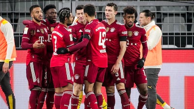 Bayern's Robert Lewandowski celebrates with teammates after scoring the penalty to make it 3-2. EPA