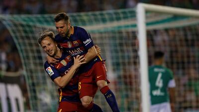 Barcelona’s Ivan Rakitic celebrates with Jordi Alba after scoring against Real Betis. Marcelo del Pozo / Reuters