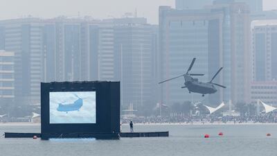 A CH-47 Chinook helicopter circles in front of the crowds on the Corniche after having dropped a special forces team in a low flying manoeuvre. Antonie Robertson / The National