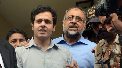 Awais Shah, left, with his father Sajjad Ali Shah, right, chief justice of Sindh's High Court, after the son was rescued from kidnappers, in Karachi, Pakistan, on July 29, 2016. Imran Ali / AP