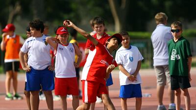 Kids participate in the distance throw event during the BSME Under 11s at the Dubai Police Officers Stadium in Dubai. Satish Kumar / The National