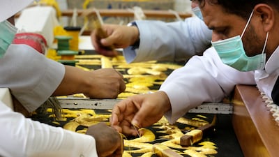 Men embroider Islamic calligraphy to prepare a drape, or Kiswa, that covers the Kaaba, the cube-shaped structure at the heart of the Grand Mosque in Mecca, Saudi Arabia.