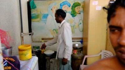 A labourer cooks fish for lunch on the roof of his villa, from which Sharjah Municipality has evicted him and his fellow workers, giving them 24 hours to find a new place to live.