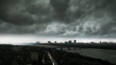 Dark clouds hover over the skyline in Hanoi, Vietnam. AFP