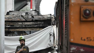 A rescue worker films near the collision site. AFP