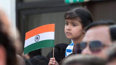 Indian families wave the flag as they celebrate independence day