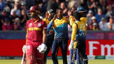 Sri Lanka's Angelo Mathews celebrates with teammates after taking the wicket of West Indies' Nicholas Pooran. Lee Smith / Reuters