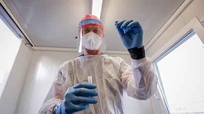 A nurse prepares to collect a swab sample at the Covid-19 test centre at Brussels Airport in Belgium. EPA