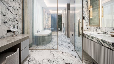 Bright breccia capraia stone marble in-laid with rare emerald quartz in the master bathroom