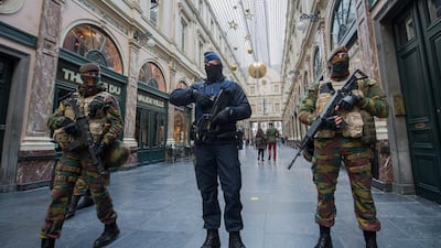 A police officer and soldiers on security duty inside Galerie de la Reine following the terror alert level being elevated to 4/4, in Brussels, Belgium, on November 22, 2015. Stephanie Lecocq/EPA