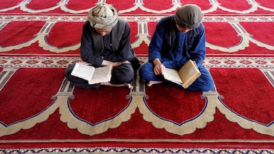 Afghan men read the Quran at a mosque during the holy month of Ramadan in Kabul, Afghanistan. Reuters