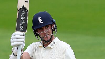England's Stuart Broad raises his bat to celebrate scoring fifty runs during the second day of the third Test match against the West Indies at Old Trafford on Saturday. AP