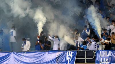 Hilal supporters let off blue and white flares in celebration. AFP