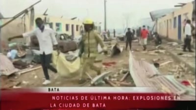 People carry a body in a sheet following explosions at a military base, according to local media, in Bata, Equatorial Guinea. Reuters