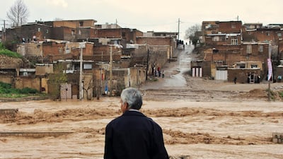 A man watches as floodwaters hit the city of Khorramabad in the western province of Lorestan, Iran. AP