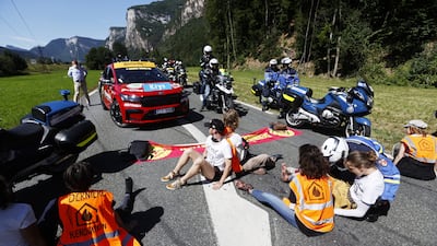 Climate-change protestors block the road during Stage 10. EPA