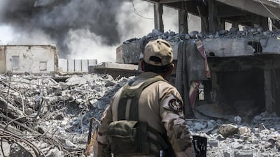 An Iraqi army soldier looks at an Iraqi forces airstrike which targeted an ISIL sniper position in Al Shifa, west Mosul. (Martyn Aim/Getty Images).