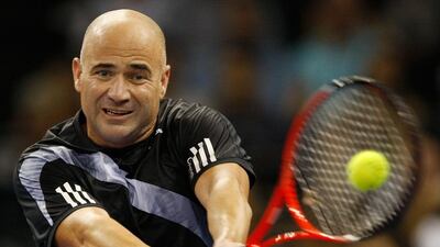 Andre Agassi, shown here returning the ball to Pete Sampras during a friendly exhibition in 2009, is considering to become the ATP's next 'super coach' but has not fully committed to the idea just yet. AP Photo/Vincent Yu