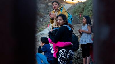Honduran migrants react as they surrender to the US Border Patrol after crossing the border into the United States. AP Photo