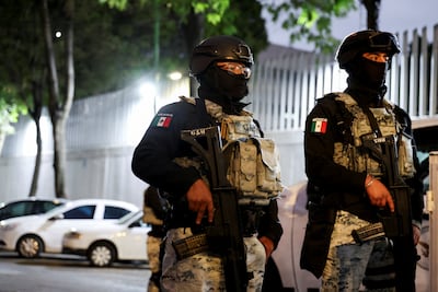 Members of Mexico's National Guard stand outside a building where the body of El Mencho is suspected of being held in Mexico City. Reuters