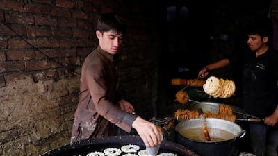 Afghan men make sweets at a small traditional factory ahead of the Eid al-Adha in Kabul, Afghanistan. Reuters