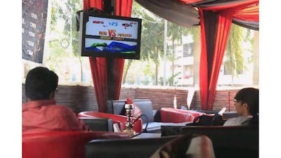 Young cricket fans in a Mumbai cafe; a Pepsi advertisement for the ICC Cricket World Cup; and a screen erected by Hyundai to showcase its brand in conjunction with the World Cup.