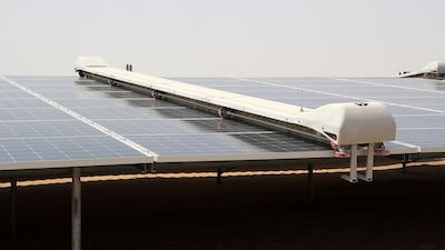 Cleaning dust from the solar panels is crucial to ensuring they work at maximum capacity. Robot cleaners run along the fields of panels throughout the day. Pawan Singh / The National