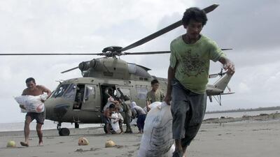 Rescue workers are struggling to bring aid and supplies to famished and destitute survivors of Typhoon Haiyan in the Philippines which may have killed more than 10,000 people, in what is feared to be the country's worst natural disaster. Tara Yap/AFP Photo