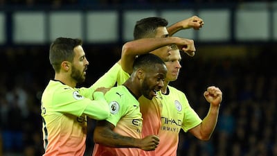 Raheem Sterling celebrates with his Manchester City teammates after scoring their third goal at Everton on Saturday. EPA