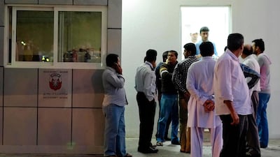 Friends, family and co-workers wait outside the Al Ain Morgue, at the Al Ain Hospital, for news about the deceased. Antonie Robertson / The National