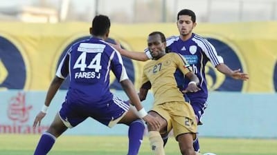 Dubai’s Abou Baca Camara tries to play the ball past Al Ain’s Fares Jumaa yesterday.