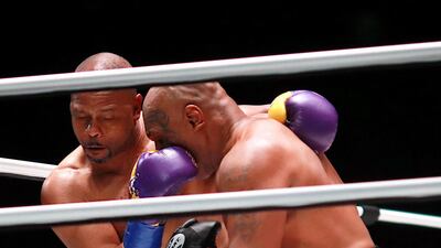 Mike Tyson and Roy Jones, Jr. trade punches during their heavyweight exhibition boxing bout. Reuters