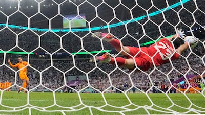 Argentina goalkeeper Emiliano Martinez saves from Virgil van Dijk of the Netherlands in the penalty shoot-out. AP