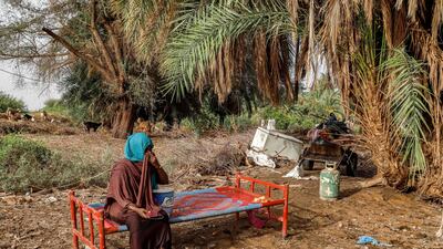 A woman sits on a salvaged bed in an area devastated by floods in Al Sagai, near Omdurman, where heavy rain has destroyed more than 450 homes in Sudan's north. AFP