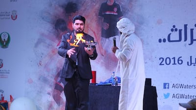 A man performs on the open air stage at the Al Gharbia Watersports Festival.