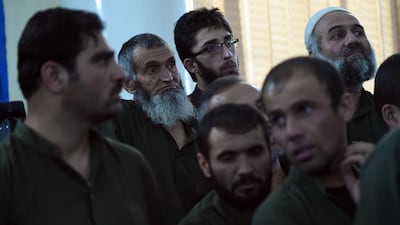 Murder suspects stand before face a trial in a court in Kabul. Wakil Kohsar / AFP