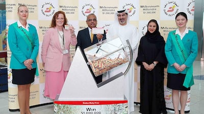 Ramesh Cidambi, chief operating officer, Salah Tahlak, executive vice president for corporate services, Sinead El Sibai, senior vice president of marketing and Mona Al Ali, vice president of HR service delivery draw Eliza M's winning ticket. Courtesy Dubai Duty Free