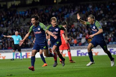 Takumi Minamino, left, after scoring Red Bull Salzburg's late equaliser against Real Sociedad. Alvaro Barrientos / AP Photo