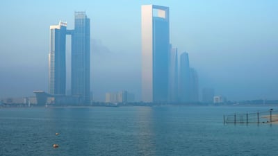 The sun rises on a foggy Wednesday morning at the Corniche. Victor Besa / The National