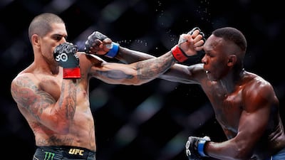Alex Pereira exchanges strikes with Israel Adesanya in their middleweight title bout at UFC 287 at Kaseya Center in Miami, Florida.