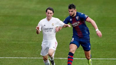 Real Madrid full-back Alvaro Odriozola hold's off Huesca's Rafa Mir. Reuters