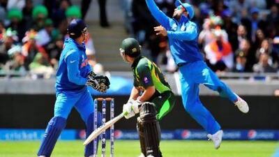 Pakistan's Kamran Akmal turns to watch India's Virat Kohli catch him out on Saturday. Glyn Kirk / AFP