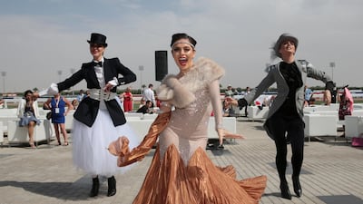 Well-dressed performers entertain the crowds ahead of the race. REUTERS