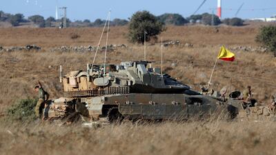 An Israeli soldier jumps off a tank in the Israeli-controlled Golan Heights, near the Israel-Syria frontier. Reuters
