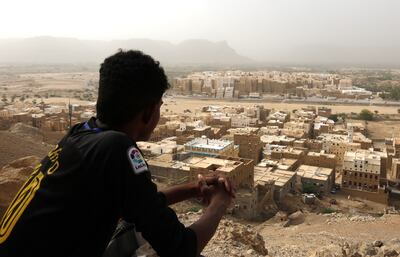 A Yemeni sits on a mountain overlooking the mud-brick 'skyscrapers' of the ancient walled city of Shibam in Hadramawt province. EPA
