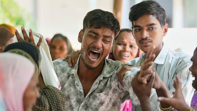 A relative of a victim of the Air India plane crash is comforted at a hospital in Ahmedabad, western India. AP Photo