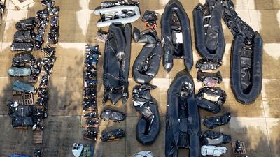 Small boats and outboard motors used by migrants to cross the Channel at a warehouse facility in Dover, Kent. PA