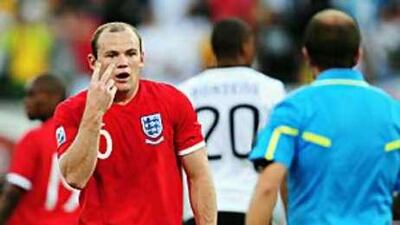England's Wayne Rooney gestures towards Mauricio Espinosa, the Uruguayan linesman who failed to spot Frank Lampard's shot that had clearly crossed the line against Germany.