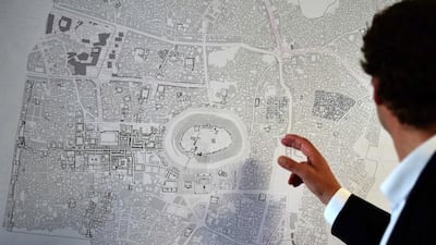 Urban planner Christoph Wessling points out locations on a map showing Syria's town of Aleppo. Lebanon readies itself for business once reconstruction begins in Syria. Tobias Schwartz / AFP